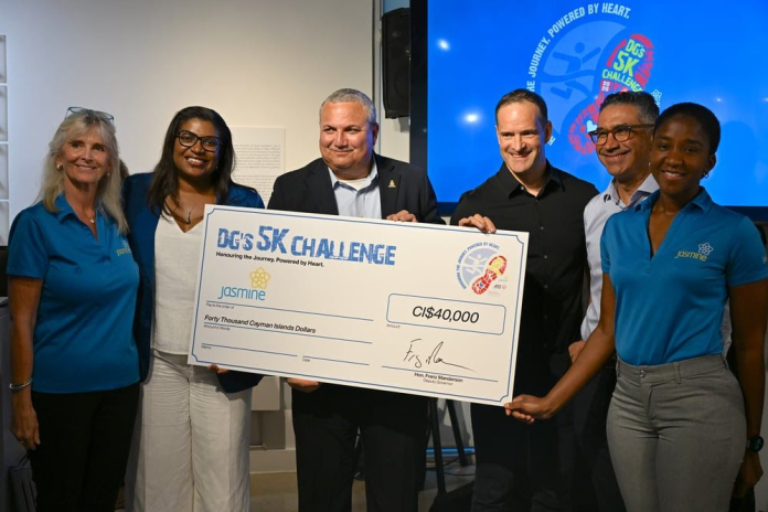 Representatives from Jasmine accept a $40,000 cheque from Deputy Governor Franz Manderson and sponsors (Photo: Cayman Islands Government)